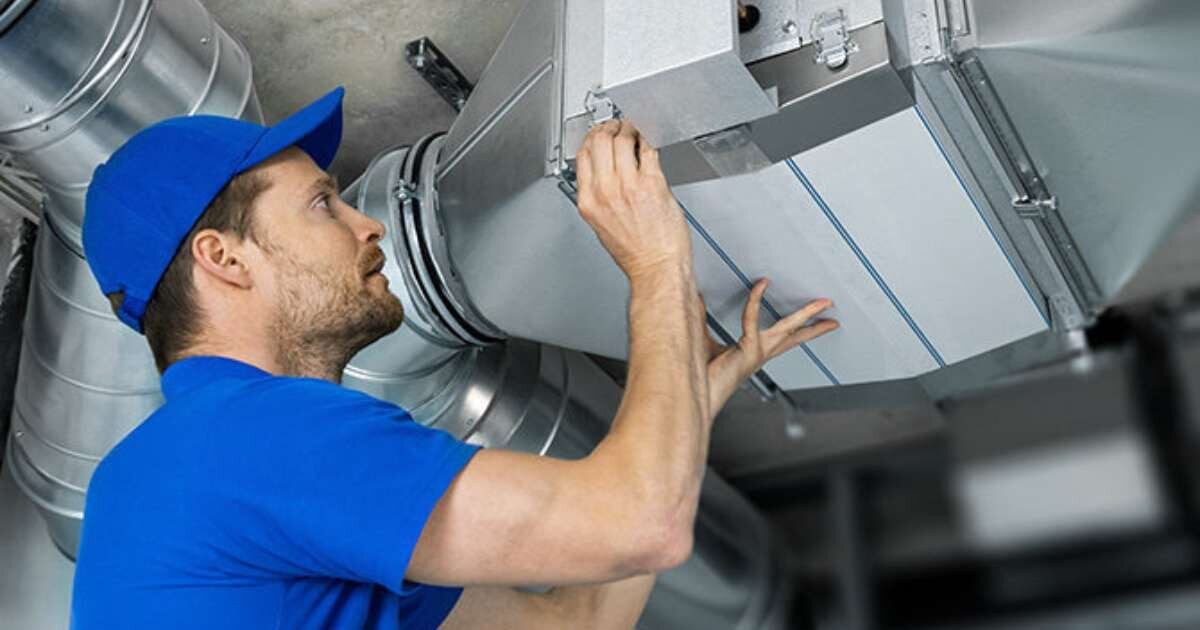 HVAC technician fixing ductwork